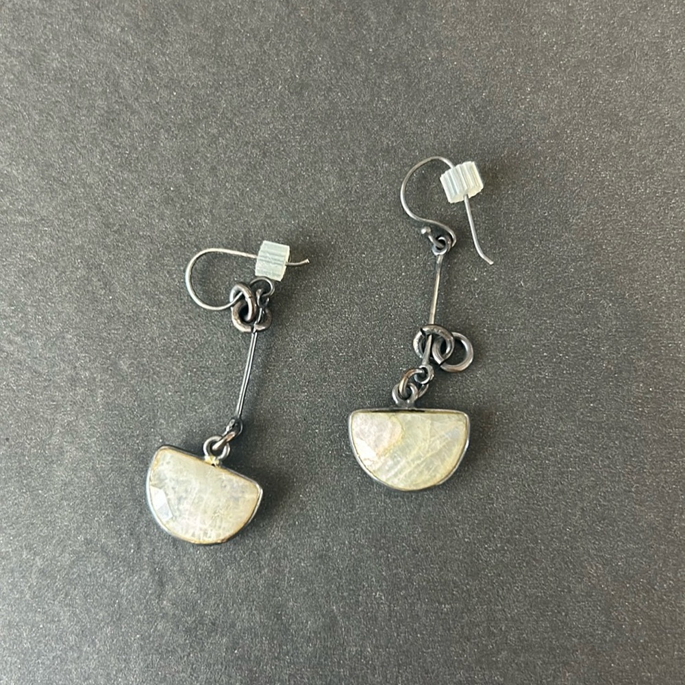 Earrings with white stone.